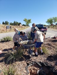 Scouts from Cub Scout Troop 22 help mix cement to put up a new flagpole at Abiquiu Lake during the National Public Lands Day event there, Sept. 24, 2022.